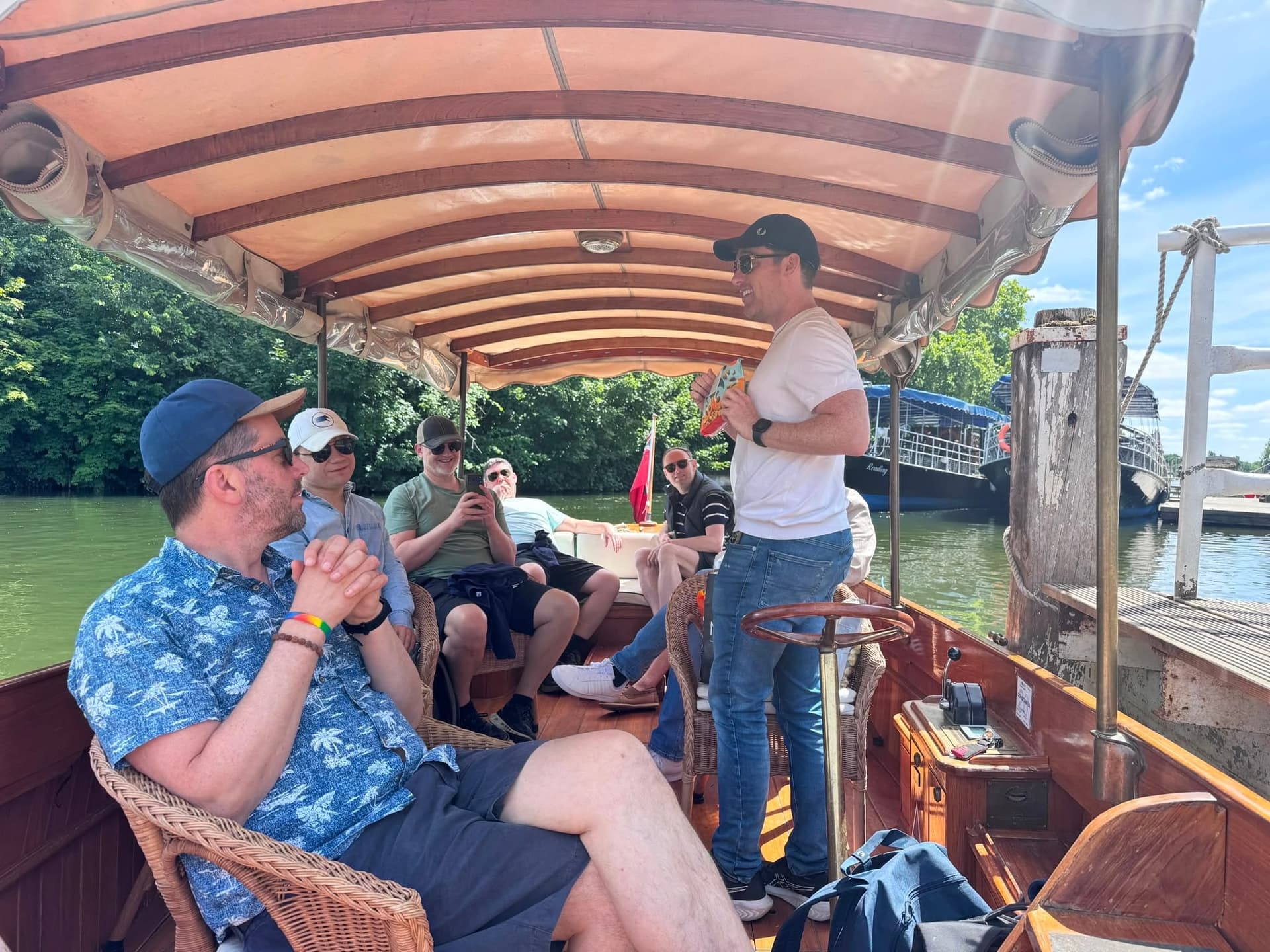Friends relax on a sunny punt trip along the river.
