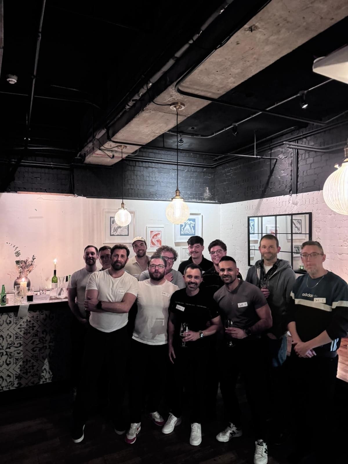 The full group poses together at the bar after a South London meet up.